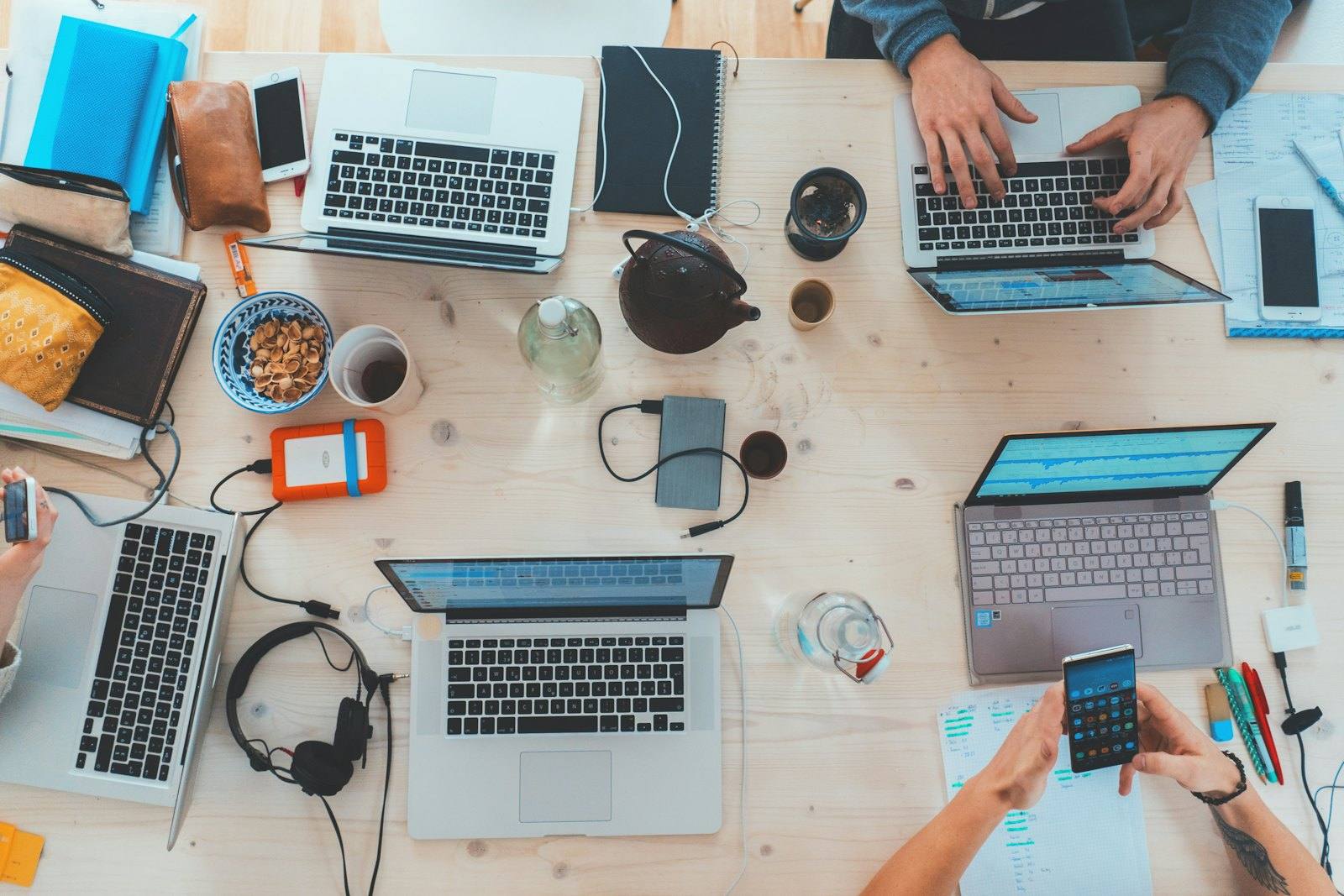Overhead view of a team working with laptops